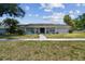 Charming one-story home with a beautiful facade, lush lawn, and inviting walkway, offering classic curb appeal at 10408 Butia Pl, Tampa, FL 33618