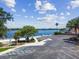 Parking lot leading to a serene beach area with a lake view at 10408 Butia Pl, Tampa, FL 33618