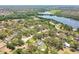Scenic aerial view showcasing houses surrounded by mature trees in a tranquil, lakeside community at 11203 Killearn Ct, Riverview, FL 33569