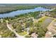 Scenic aerial shot of a house by a lake surrounded by trees and other homes in a peaceful neighborhood at 11203 Killearn Ct, Riverview, FL 33569