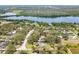 Aerial view of homes nestled among lush trees near a calm lake in a serene residential area at 11203 Killearn Ct, Riverview, FL 33569