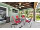 Covered back porch with red chairs, table, and grill at 11203 Killearn Ct, Riverview, FL 33569