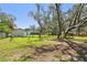 Expansive backyard with lush lawn and mature trees, offering ample shade at 11203 Killearn Ct, Riverview, FL 33569