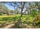 Beautiful backyard with mature trees, a gazebo, and well-manicured lawn at 11203 Killearn Ct, Riverview, FL 33569