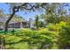 Spacious backyard with mature trees, a screened pool area, and lush landscaping for privacy at 11203 Killearn Ct, Riverview, FL 33569