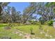 Lush backyard with mature trees and a gazebo, perfect for outdoor entertaining at 11203 Killearn Ct, Riverview, FL 33569