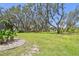 Spacious backyard with mature trees and landscaped features, ideal for outdoor living at 11203 Killearn Ct, Riverview, FL 33569