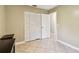 Bedroom featuring tile flooring, a closet with louvered doors, and a door leading to another room at 11203 Killearn Ct, Riverview, FL 33569