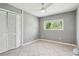 Neutral bedroom featuring tile flooring, a closet with louvered doors, and a window with a lovely view at 11203 Killearn Ct, Riverview, FL 33569