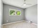 Bedroom features neutral paint, tile floors, a ceiling fan, and a window with a pleasant view at 11203 Killearn Ct, Riverview, FL 33569