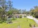 Charming home with well-maintained lawn, mature trees, and a spacious driveway at 11203 Killearn Ct, Riverview, FL 33569