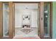 Welcoming foyer featuring tile flooring, storage bench, and convenient coat hooks at 11203 Killearn Ct, Riverview, FL 33569