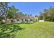 Charming single-story home with a well-manicured lawn and mature trees in a serene setting at 11203 Killearn Ct, Riverview, FL 33569