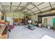 Large garage with metal frame, lots of room for storage and work area, shelving units and furnishings at 11203 Killearn Ct, Riverview, FL 33569