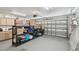 A well-lit, spacious garage with storage racks and a side entrance offers practical utility and organization at 11203 Killearn Ct, Riverview, FL 33569