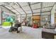 Bright and spacious garage featuring metal framing, work tables, storage solutions, and natural light at 11203 Killearn Ct, Riverview, FL 33569
