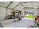 Open garage with overhead metal framework and plenty of space for vehicles or a workshop at 11203 Killearn Ct, Riverview, FL 33569