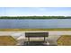 Picturesque lake view with bench seating offering a serene outdoor experience and relaxing neighborhood amenity at 11203 Killearn Ct, Riverview, FL 33569