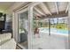 Looking out the glass sliding doors to the screened-in patio with pool, creating an inviting space at 11203 Killearn Ct, Riverview, FL 33569