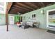 Covered patio featuring outdoor seating, fan, and access to backyard at 11203 Killearn Ct, Riverview, FL 33569