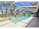 The backyard features a screened-in pool and spa with a lounging area at 11203 Killearn Ct, Riverview, FL 33569