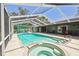 Enjoy the Florida sunshine in this lovely screened pool with an integrated jacuzzi and ample lounge space at 11203 Killearn Ct, Riverview, FL 33569
