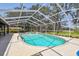 The backyard features a screened-in pool and spa with a lounging area at 11203 Killearn Ct, Riverview, FL 33569