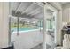 View of the covered pool from the interior featuring a screened-in enclosure and relaxing outdoor space at 11203 Killearn Ct, Riverview, FL 33569