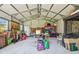 This storage shed's interior is spacious with abundant storage racks and is well lit at 11203 Killearn Ct, Riverview, FL 33569