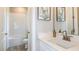 Bright bathroom with white cabinets, quartz countertop, and a combined shower and tub at 11236 Kingly Ln, Odessa, FL 33556