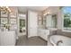 Spacious bathroom showcasing double vanities, a soaking tub, and modern fixtures, offering a spa-like experience at 11236 Kingly Ln, Odessa, FL 33556