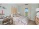 A bedroom with beachy decor, featuring surfboards as a headboard and light colors for a relaxing feel at 11236 Kingly Ln, Odessa, FL 33556