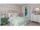 Charming bedroom with colorful wallpaper, and complementing pastel bedding and decor at 11236 Kingly Ln, Odessa, FL 33556