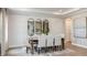 Elegant dining room featuring a wooden table and seating for eight, complemented by modern decor and lighting at 11236 Kingly Ln, Odessa, FL 33556