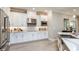Bright kitchen with white cabinets, stainless steel appliances, sleek countertops, and modern fixtures at 11236 Kingly Ln, Odessa, FL 33556