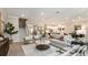 Open-concept living space with modern furnishings, a cozy atmosphere, and seamless kitchen access at 11236 Kingly Ln, Odessa, FL 33556