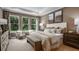 Serene primary bedroom with a neutral color palette, large windows, and elegant furnishings at 11236 Kingly Ln, Odessa, FL 33556