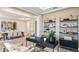 A stylish office space with dark furniture, complemented by decor and an adjacent dining area at 11236 Kingly Ln, Odessa, FL 33556