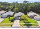 An aerial view showcases the home's location on a lush, green lot with mature trees at 11446 Sinatra Ct, New Port Richey, FL 34654