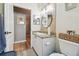 Neutral-toned bathroom featuring granite counters, round mirror, and tiled walls at 11446 Sinatra Ct, New Port Richey, FL 34654