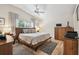 Cozy bedroom with a neutral color palette, wood furniture, and ample natural light at 11446 Sinatra Ct, New Port Richey, FL 34654