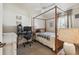 Inviting bedroom features a canopy bed, desk, and soft natural light at 11446 Sinatra Ct, New Port Richey, FL 34654