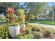 Landscaped community entrance with decorative planters and manicured greenery at 11446 Sinatra Ct, New Port Richey, FL 34654