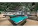 Spacious game room featuring multiple billiard tables, benches, and ample lighting for entertainment at 11446 Sinatra Ct, New Port Richey, FL 34654