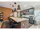 Modern kitchen featuring an island with bar seating, stainless steel appliances, and sleek cabinetry at 11446 Sinatra Ct, New Port Richey, FL 34654