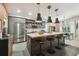 Modern kitchen with an island, stainless steel appliances, and stylish pendant lighting at 11446 Sinatra Ct, New Port Richey, FL 34654