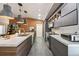 Modern kitchen showcases an island with bar seating, stainless steel appliances, and neutral toned cabinets at 11446 Sinatra Ct, New Port Richey, FL 34654