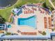 Aerial view of the community pool and spa with ample lounge chairs for residents at 11446 Sinatra Ct, New Port Richey, FL 34654