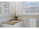 A well-lit bathroom with a vanity, granite countertop, and decorative tile accents at 126 14Th Ne Ave, St Petersburg, FL 33701