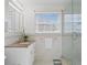 Bathroom featuring a vanity with a granite countertop and a glass-enclosed shower at 126 14Th Ne Ave, St Petersburg, FL 33701